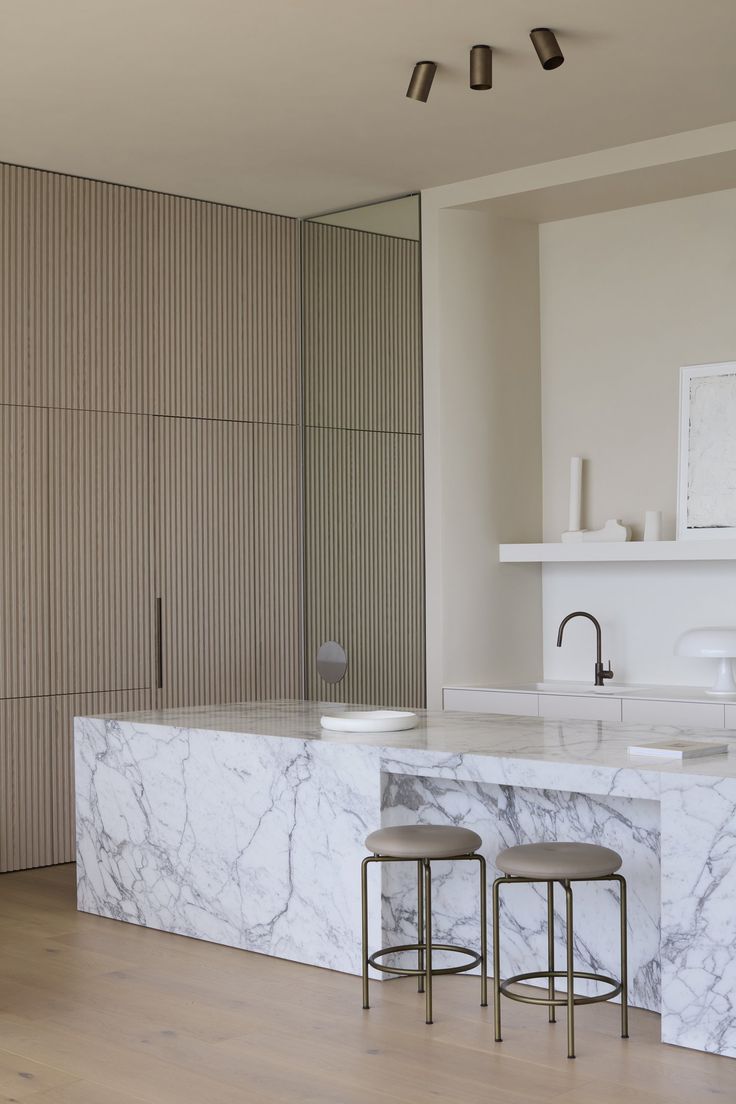 two stools sit in front of a marble counter