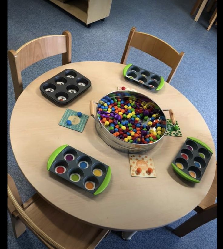 a wooden table topped with lots of toys