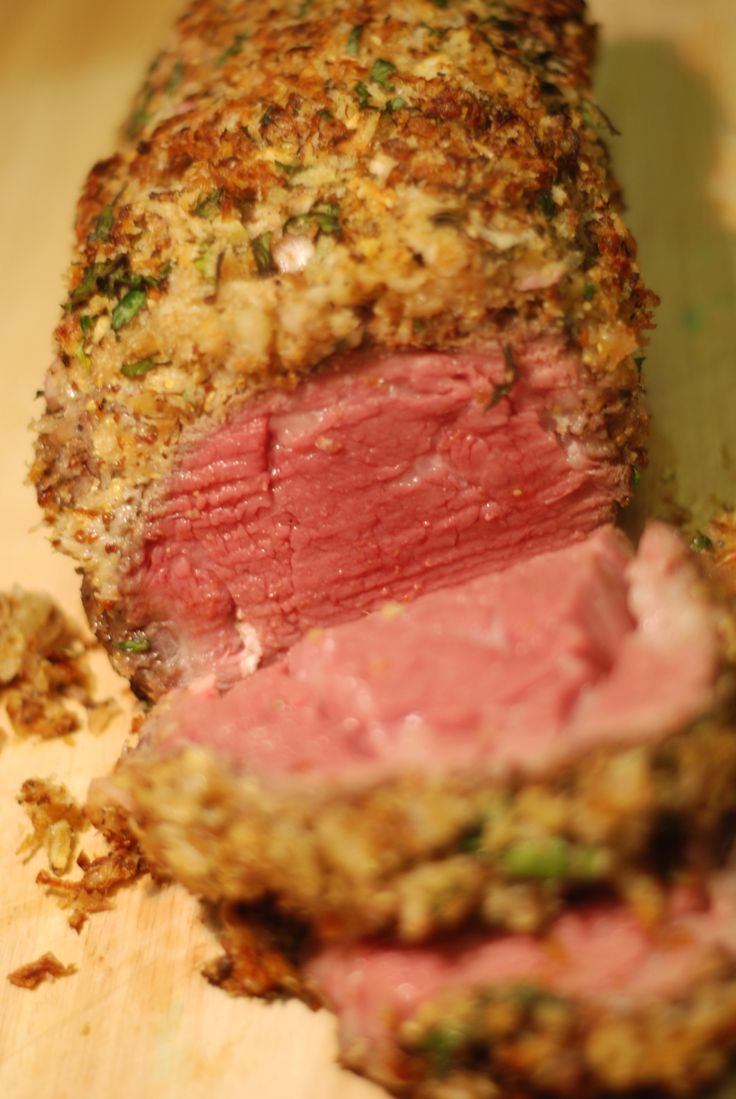 a meatloaf is cut in half on a cutting board