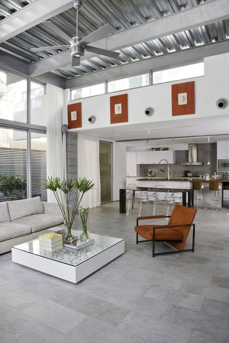 a living room filled with furniture and windows