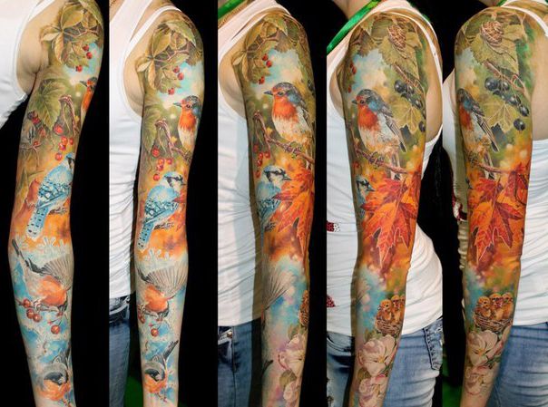 tattoos on the arms and arm of a woman with colorful flowers, birds and butterflies