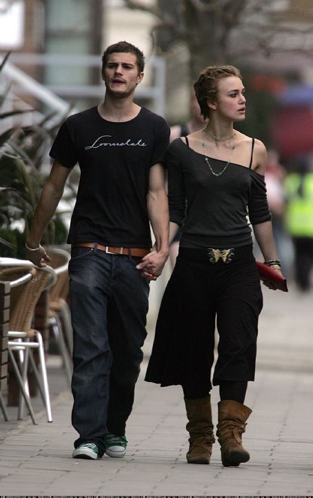 a man and woman walking down the street