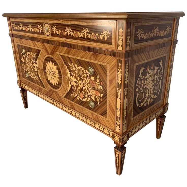 an ornately decorated wooden cabinet with intricate carvings on the front and sides, against a white background