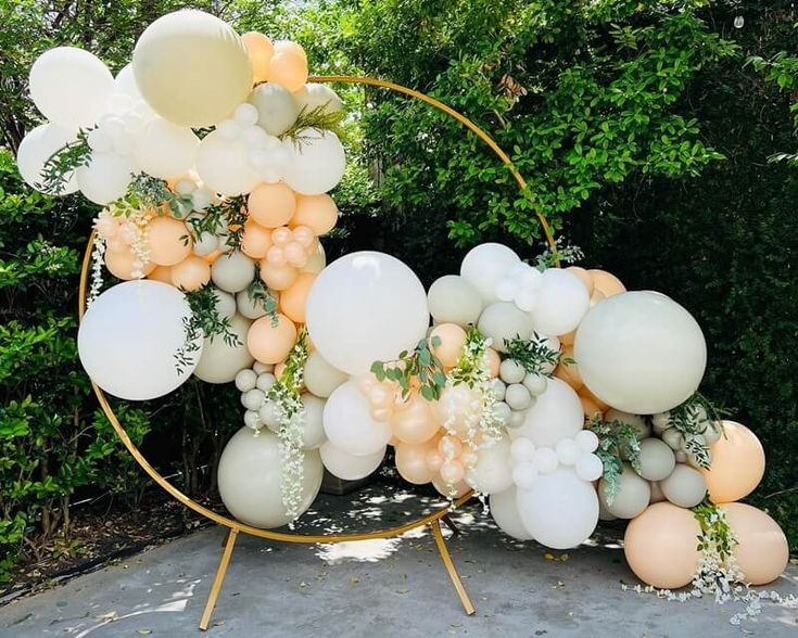 balloons and greenery are arranged in a circle