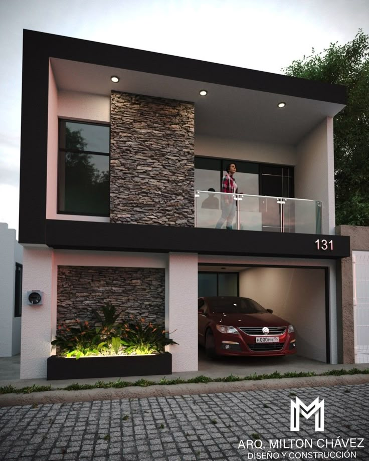 a car is parked in front of a modern house with an open garage door and balcony