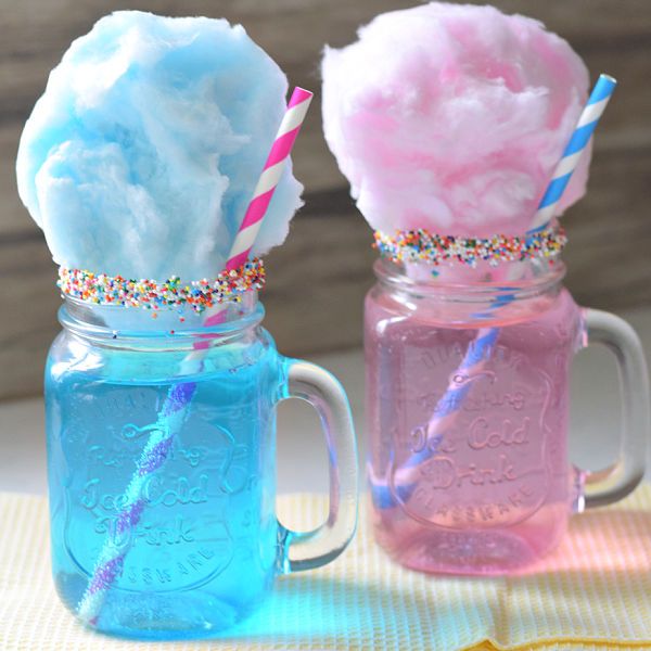 two mason jars filled with ice cream and sprinkles, one is pink and the other blue