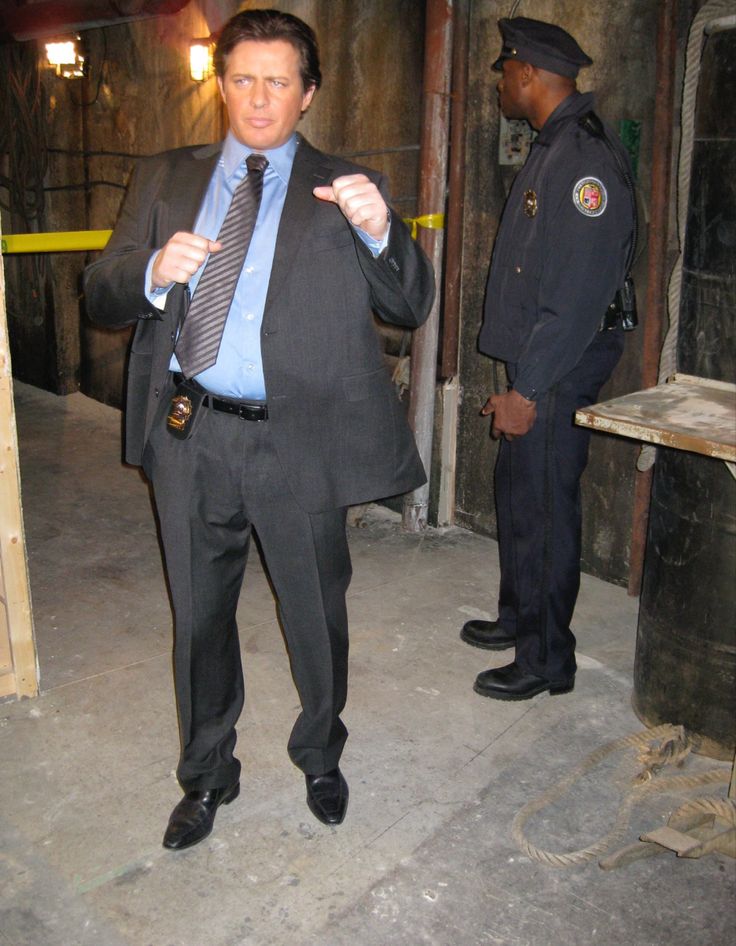 a police officer standing next to a man in a suit