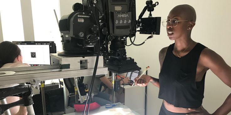 a woman standing in front of a camera