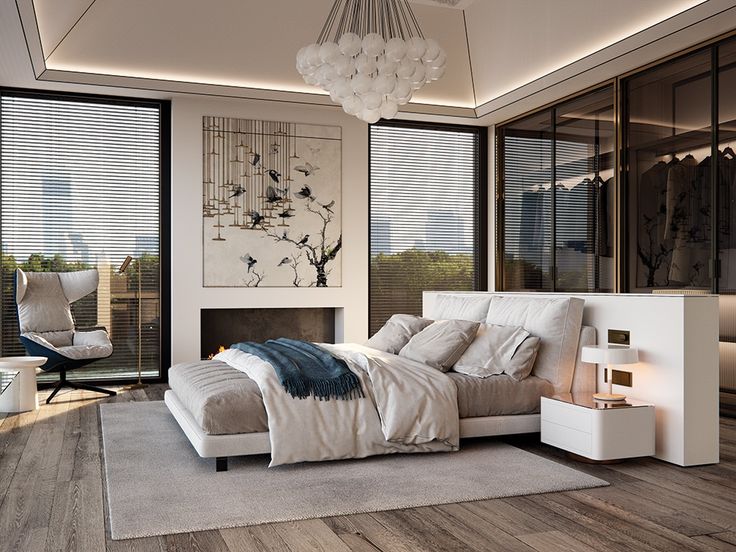 a bedroom with a bed, dresser and chair in front of large windows that look out onto the outdoors