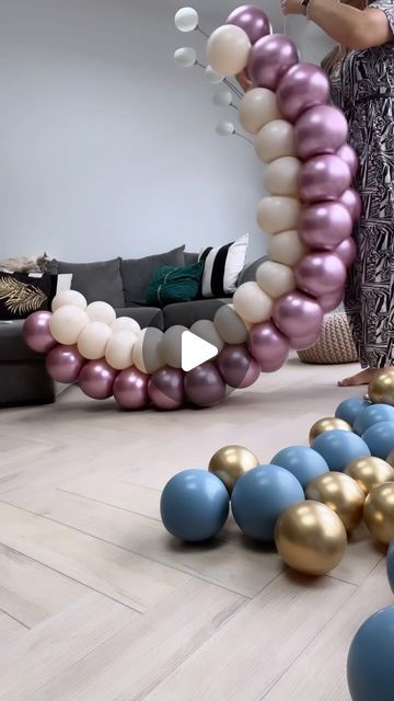 a woman standing in front of balloons on the floor