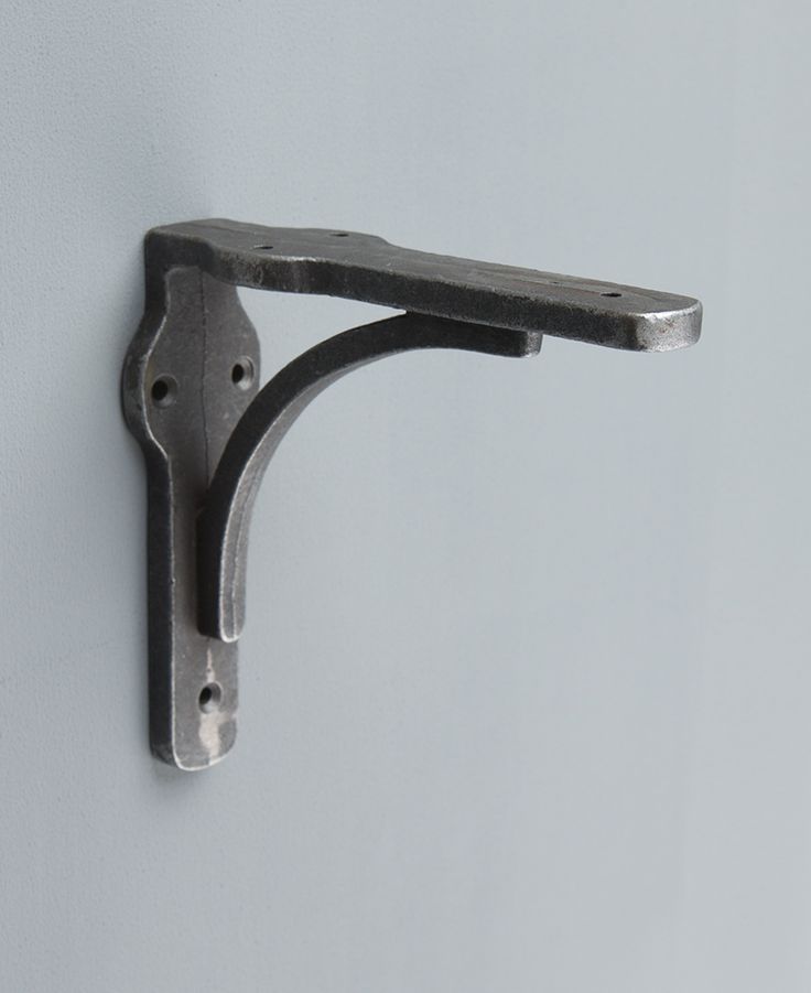 a metal hook on the side of a wall