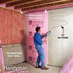 a man standing in front of a wall that is being insulated with pink joists