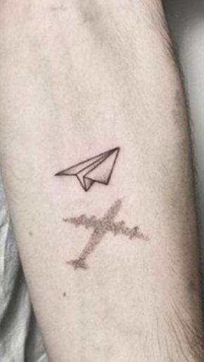 a small airplane tattoo on the left forearm and arm, with an arrow in the middle