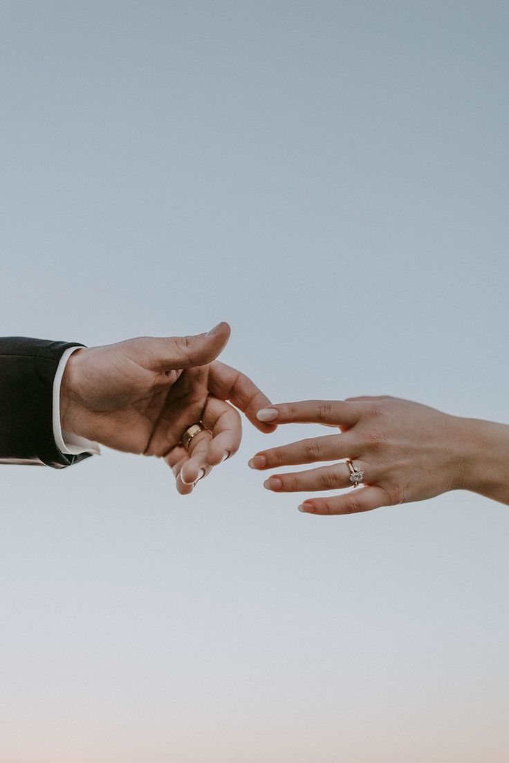 two people reaching out their hands to each other