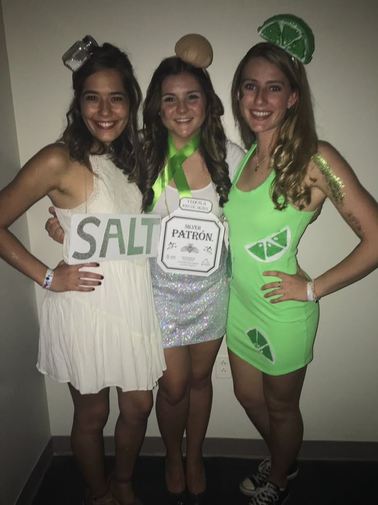 three girls dressed up in costumes posing for the camera with one holding a sign that says salt on it