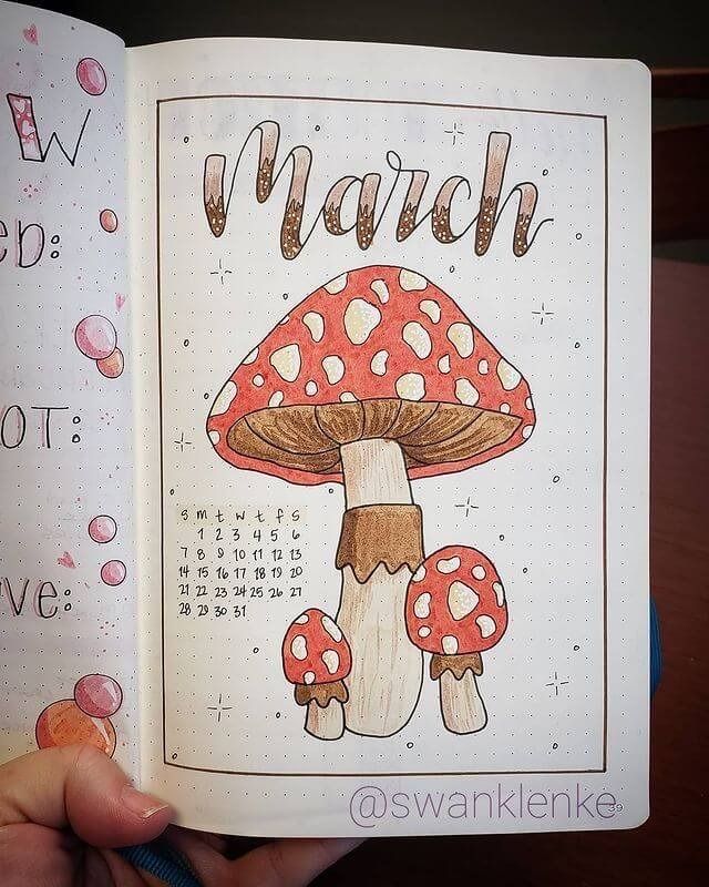 a hand holding an open coloring book in front of a drawing of a mushroom with the words march on it