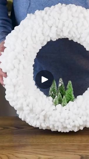 someone is making a wreath out of fake snow