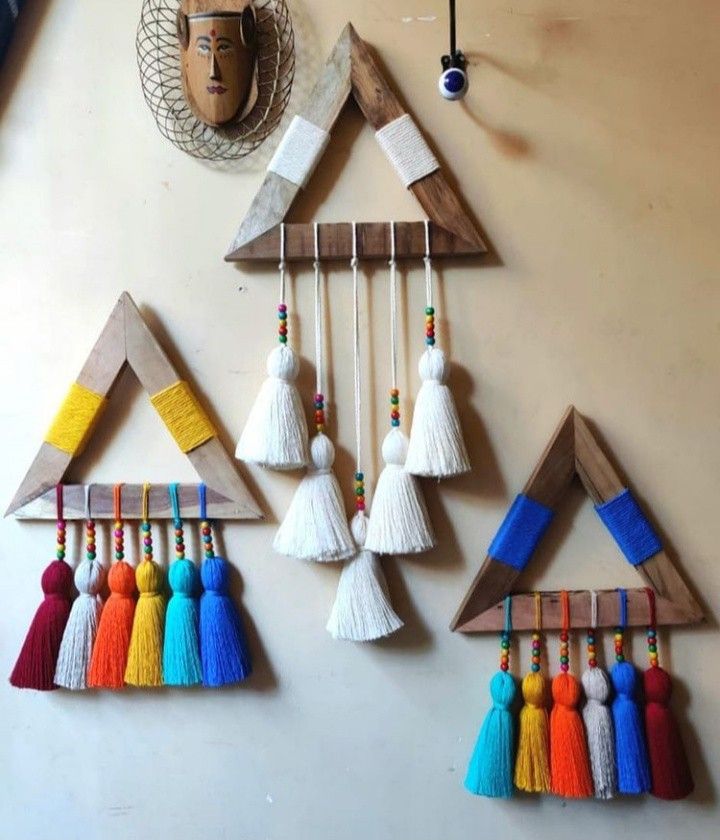 the wall is decorated with colorful tassels and hanging on it's sides