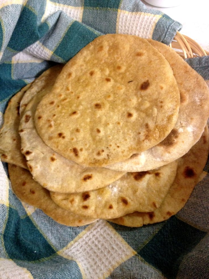 three pita breads stacked on top of each other in a wicker basket