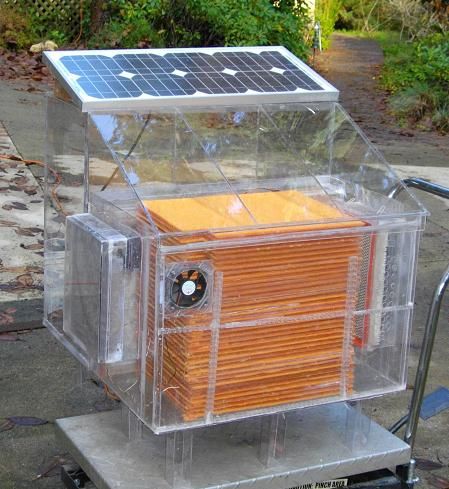 a solar powered box sitting on top of a metal cart