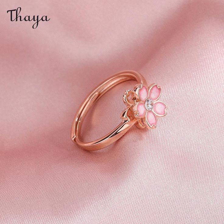 Capture the essence of cherry blossom season with our Silver Sakura Spinner Ring. This elegant piece tells a story of beauty and renewal, as delicate petals bloom and dance in the breeze. The spinner design allows for a soothing sensation, perfect for those seeking balance and serenity in their daily lives. Elevate your style with this stunning symbol of hope and new beginnings.   - Brand: Thaya  - Material: S925 Silver  - Weight : About 2.34g  - Size: Stack Mouth 14th  - Style: Flower  - Gender: Women Delicate Flower Ring For Spring Gift, Delicate Spring Flower Ring Gift, Dainty Blossom Jewelry For Spring, Dainty Blossom Color Jewelry For Spring, Feminine Blossom Jewelry For Spring, Rose Gold Jewelry For Anniversary In Spring, Rose Gold Jewelry For Spring Anniversary, Blossom Flower Jewelry For Spring, Spring Wedding Jewelry With Petal Design