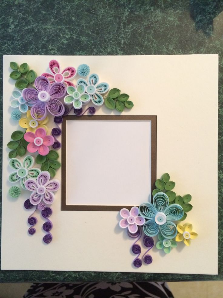 paper flowers are arranged in the shape of a frame