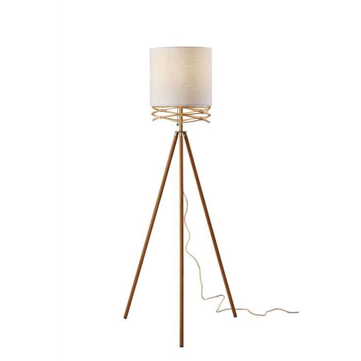 a wooden tripod floor lamp with a white shade on the top and a cord running through it