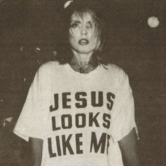 a woman wearing a jesus looks like me t - shirt