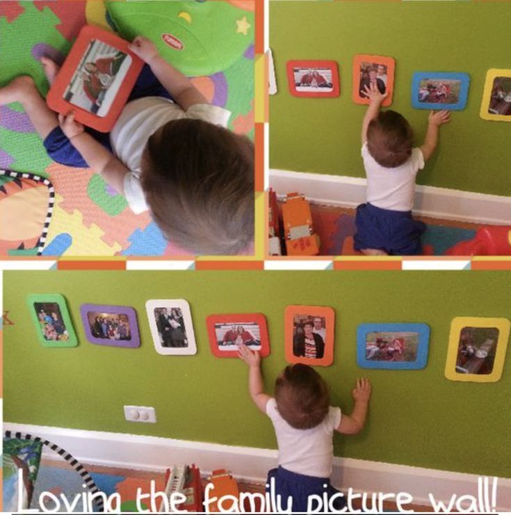 there is a child playing with pictures on the wall