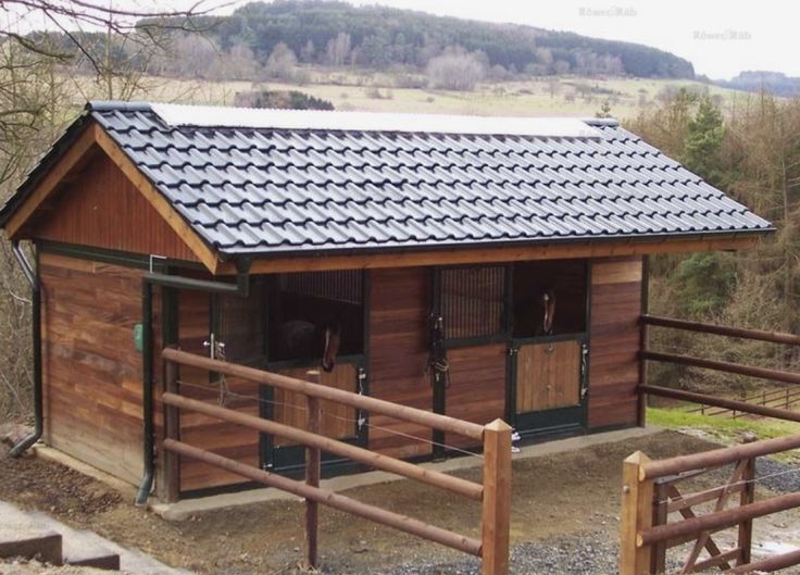 a small wooden building with a metal roof