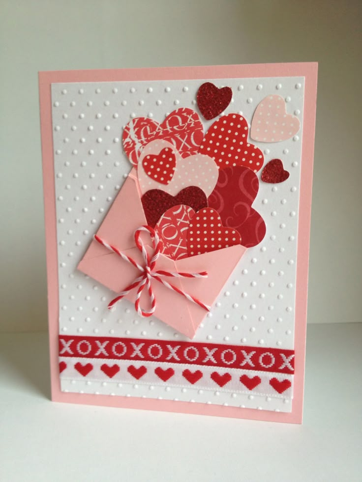 a valentine's day card with hearts and ribbons on the front, tied in a bow