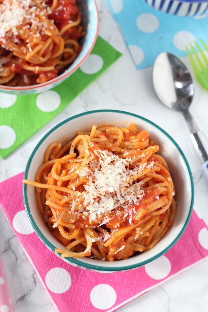 two bowls of pasta with sauce and parmesan cheese