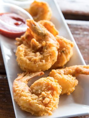 fried food on a white plate with dipping sauce