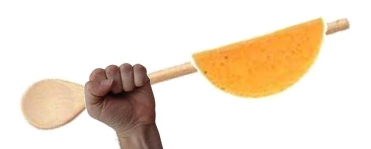 a hand holding a wooden paddle over a white background