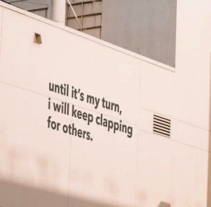 a sign on the side of a building that says until it's my turn, i will keep clapping for others