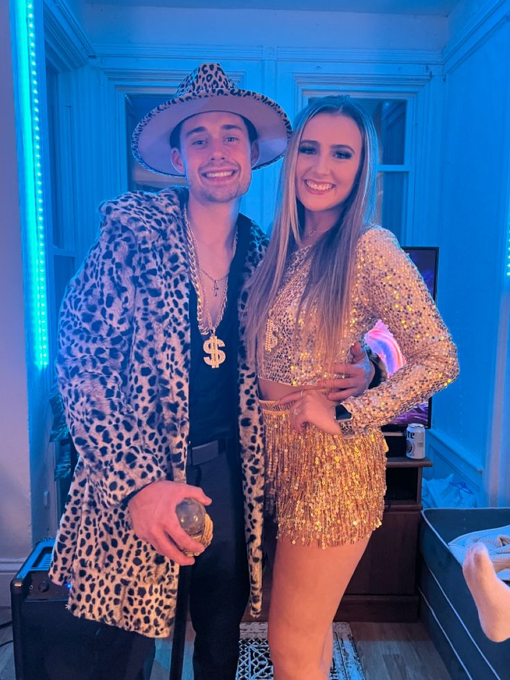 the man and woman are dressed up in animal print outfits, posing for a photo