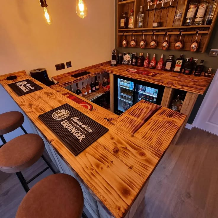 a wooden bar with stools in front of it