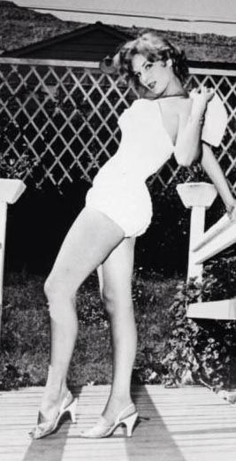 an old black and white photo of two women in swimsuits on a deck