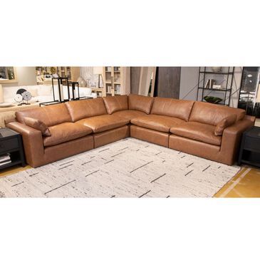 a brown leather sectional sofa sitting on top of a rug