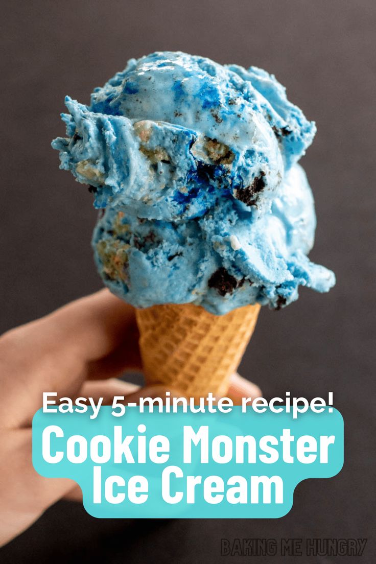 a hand holding an ice cream cone filled with cookie monster ice cream