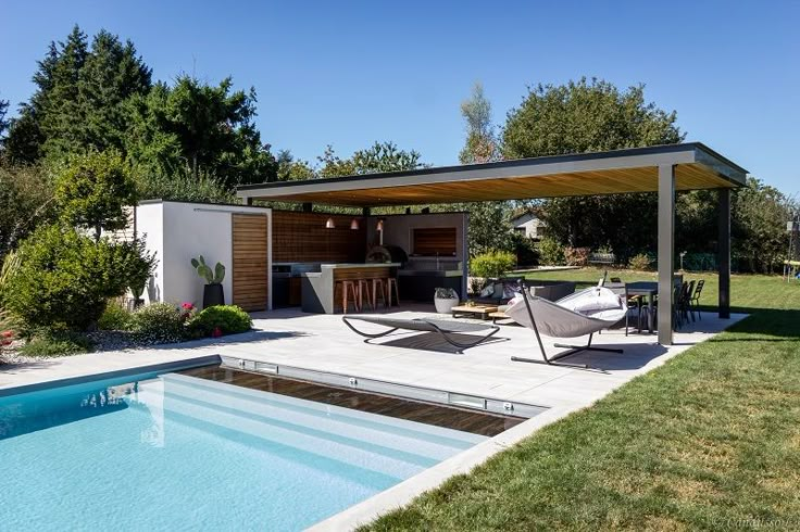 an outdoor living area next to a swimming pool