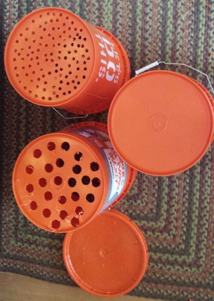 three orange canisters sitting on top of a carpet