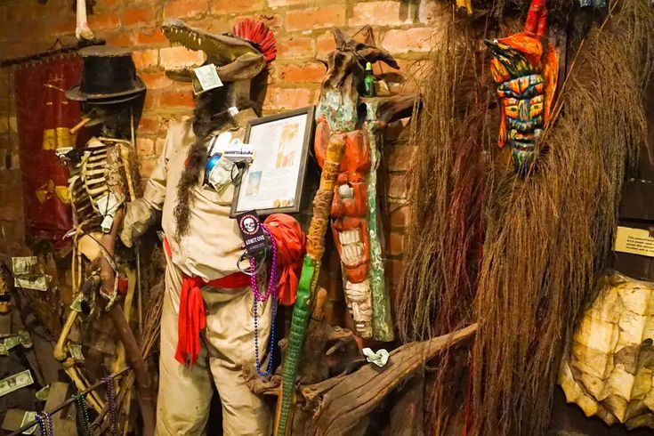 an assortment of scarecrows are on display in a shop window with brick walls