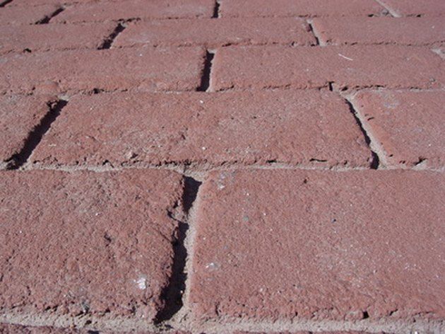 a close up of a brick sidewalk that is red