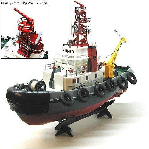 a toy boat is sitting on a stand with an oil rig in the back ground