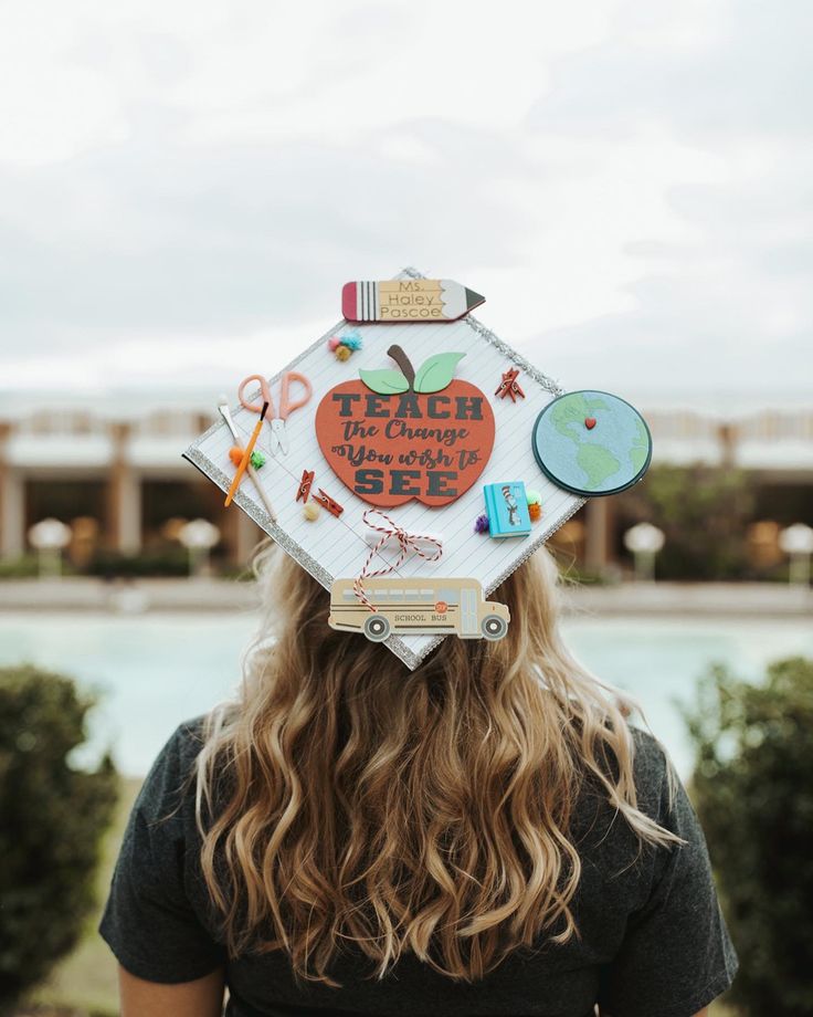 a woman with long hair wearing a graduation cap