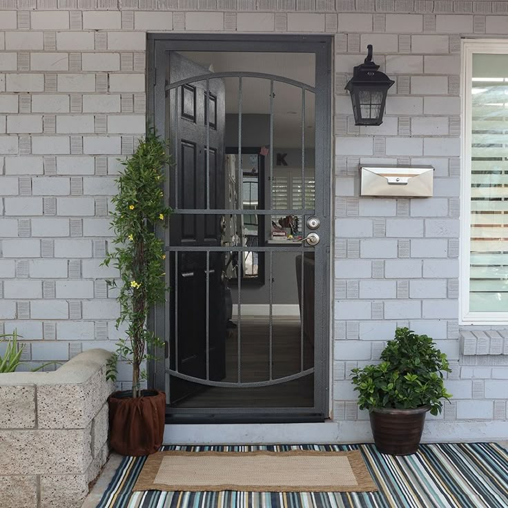 the front door to a house with potted plants