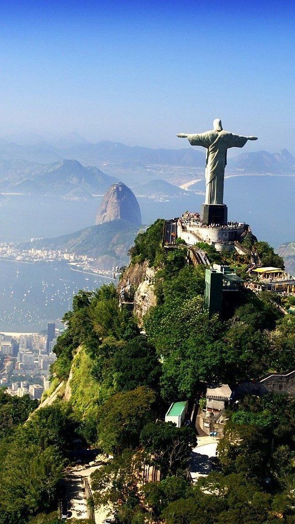 the statue of christ stands on top of a mountain