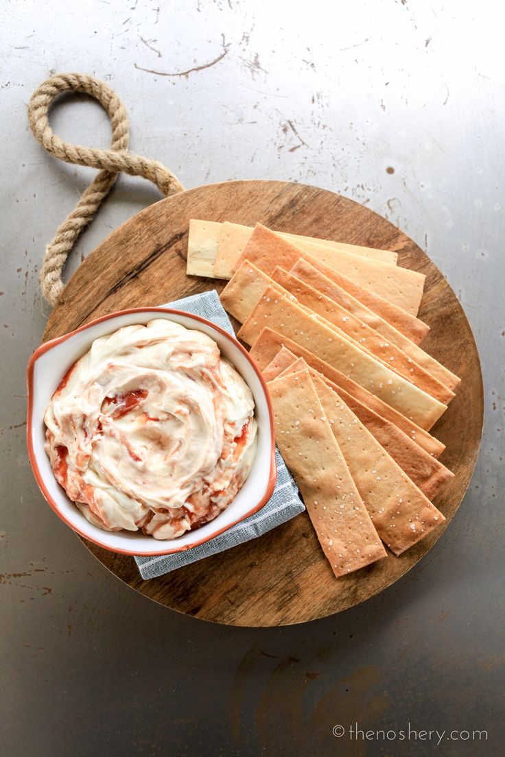 a plate with crackers and dip on it