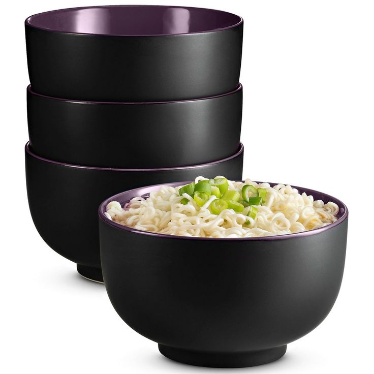 three black bowls filled with rice and lettuce